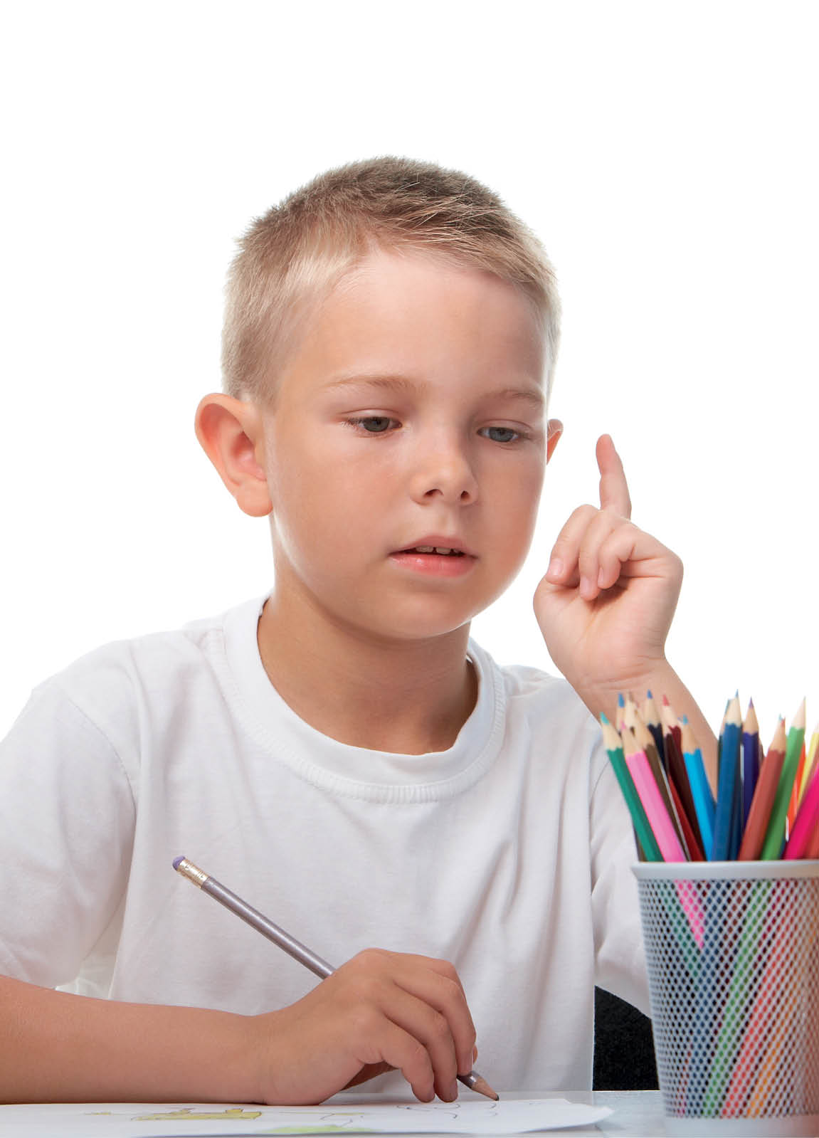 Portrait of cute youngster sitting among stacks of books and thinking while drawing